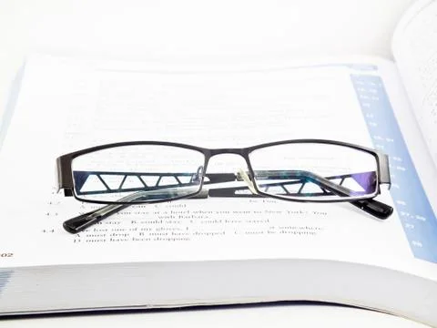 Glasses on book Stock Photos