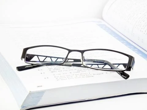 Glasses on book Stock Photos
