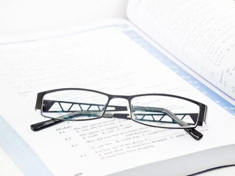 Glasses on book Stock Photos
