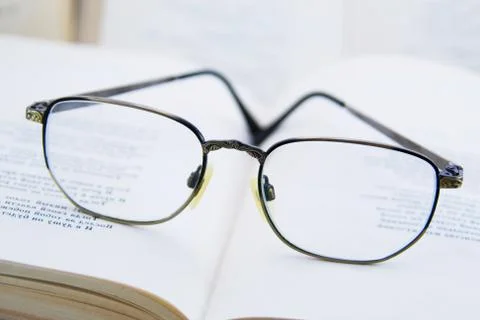 Glasses on the book Stock Photos