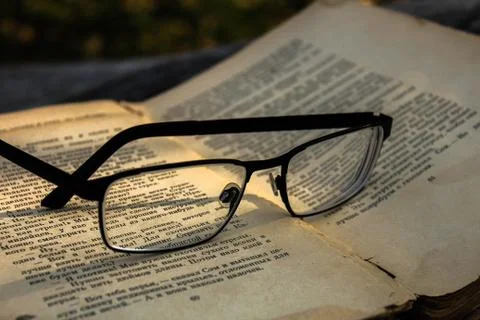 Glasses on the book Stock Photos