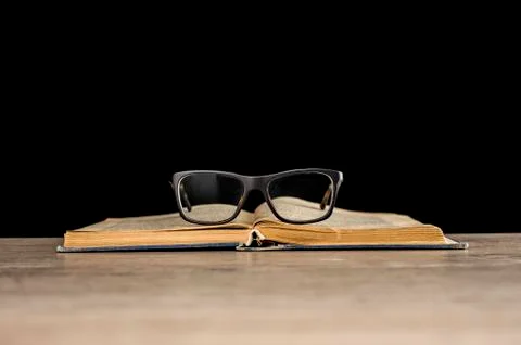 Glasses on book Stock Photos