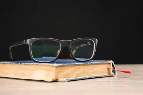 Glasses on book Stock Photos