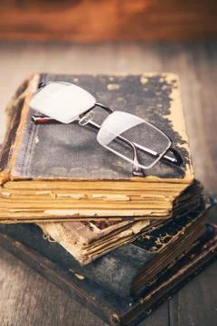 Glasses on the book Stock Photos