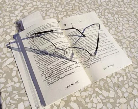 Glasses on the book Stock Photos