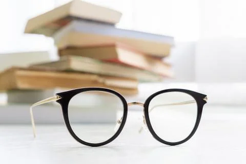 Glasses with books on the background Stock Photos