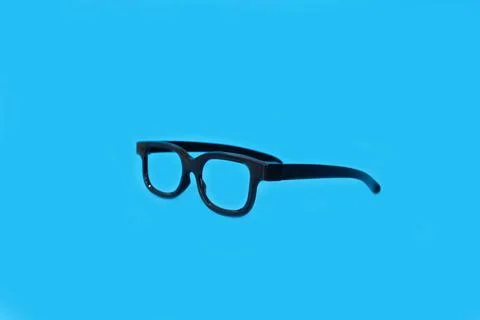 Glasses on a bright blue background Stock Photos