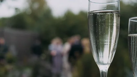 Glasses with bubbles on the background of a buffet table with guests Stock Footage 272312758