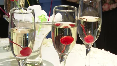 Glasses of champagne are on the table, inside a red cherry, wedding celebration Stock Footage 123922919