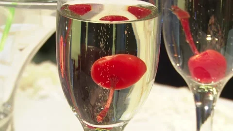 Glasses of champagne are on the table, inside a red cherry, a wedding Stock Footage 123922983