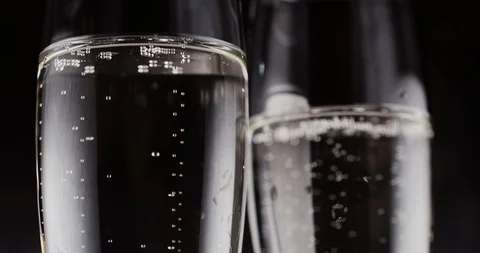Glasses with champagne bubbles on dark background Stock Footage 87319237