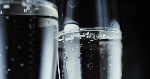 Glasses with champagne bubbles on dark background 스톡 동영상 87319264