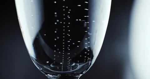 Glasses with champagne bubbles on dark background Stock-Footage 87319441