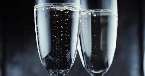 Glasses with champagne bubbles on dark background Stock Footage 87320186