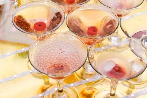 Glasses of champagne with cherry, bubbles on the surface of the glass Foto stock