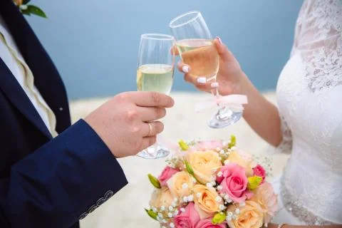 Glasses of champagne in the hands  the bride and groom in the wedding day Stock Photos