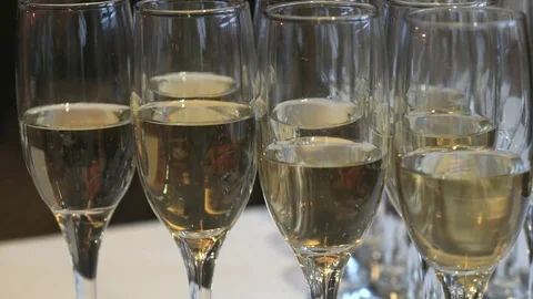 Glasses with champagne on party table. Close-up Stock Footage 76941410