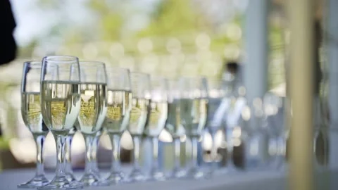 Glasses of champagne stand on table Stock Footage 156603843