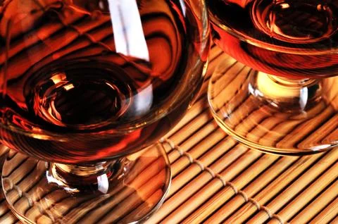 Glasses of cognac on the table Stock Photos