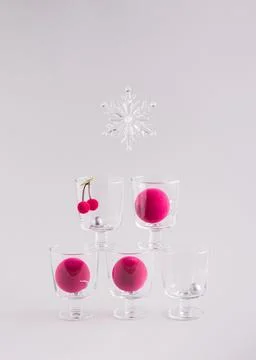 Glasses with decoration inside them in form of Christmas tree on grey background Stock Photos
