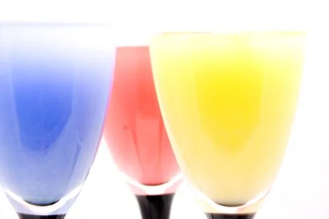 Glasses with different colored drinks isolated on white Stock Photos