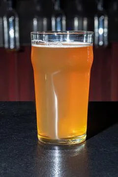 Glasses with different types of craft beer on a wooden bar. In glasses and bo Фото