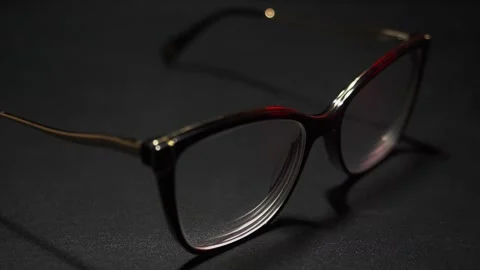 Glasses displayed in close-up on a black background showing different angles Stock Footage 324839240