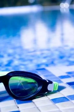 Glasses for diving on the edge of a summer pool Stock Photos