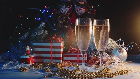 Glasses with drinks are on the background of New Year's gifts. Stock Footage 144892795