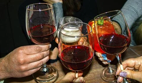 Glasses of drinks in hands Stock Photos