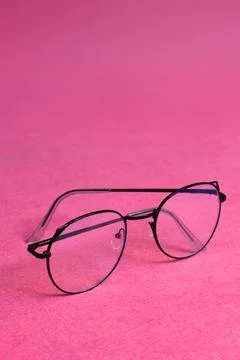 Glasses, eyeglasses in black frames with space for text, on pink background Stock Photos