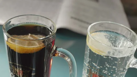 Glasses filled with drinks and magazines spread out Stock Footage 166362682