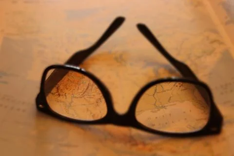 Glasses focused on map Stock Photos