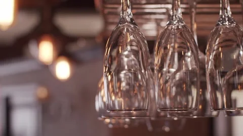 Glasses glitter over the bar Stockbeeldmateriaal 159057944