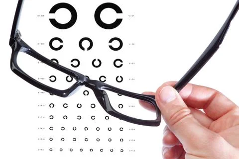 Glasses in the hand of a man on the background of the table Golovin. Close-up Stock Photos