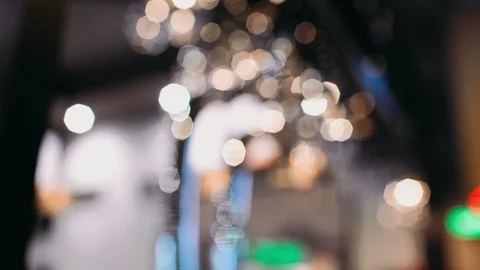 Glasses hanging on the rack in the bar under the light Video stock 101639598
