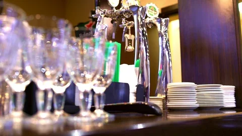 Glasses hanging on the rack in the bar under the light Stock Footage 101639612