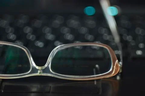 Glasses on the keyboard Stock Photos
