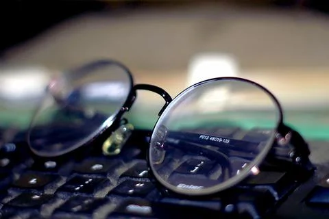 Glasses on the keyboard Stock Photos