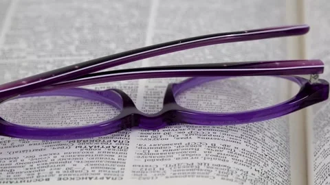 Glasses lie on the book close-up Stock Footage 141373557