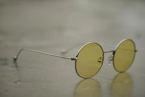 Glasses with light frames and yellow and round lenses 写真素材