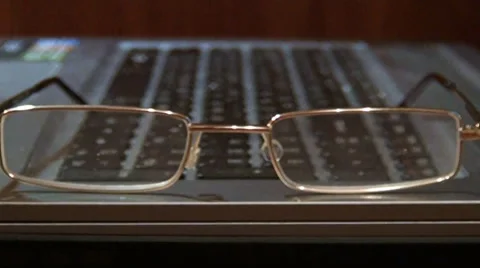 Glasses lying on a keyboard Stock-Footage 33754973