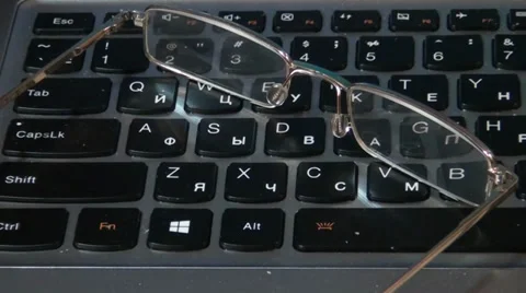 Glasses lying on a keyboard Stock-Footage 33754976