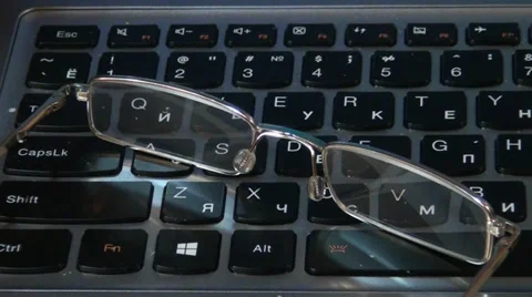 Glasses lying on a keyboard Stock-Footage 33754977