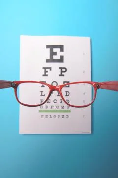 Glasses lying on snellen test chart 스톡 사진