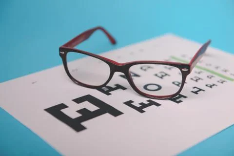 Glasses lying on snellen test chart 스톡 사진