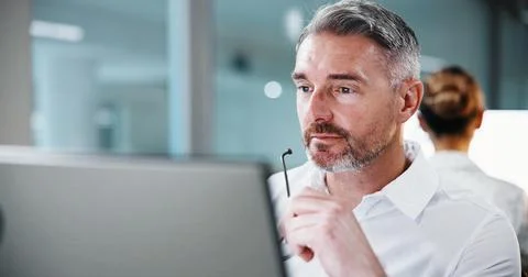 Glasses, man and thinking with computer in office for trade execution, risk Stock Photos