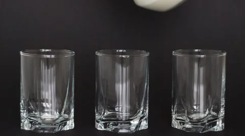 Glasses of milk on a dark background Stock Footage 1071432