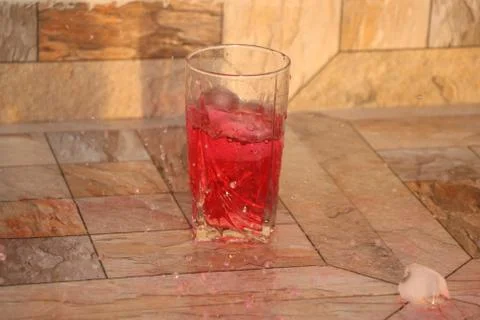 Glasses with motion splash drink Stock Photos