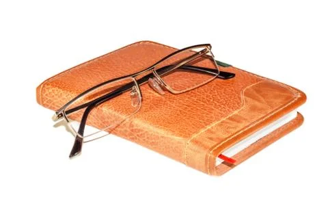 Glasses on the notebook Stock Photos